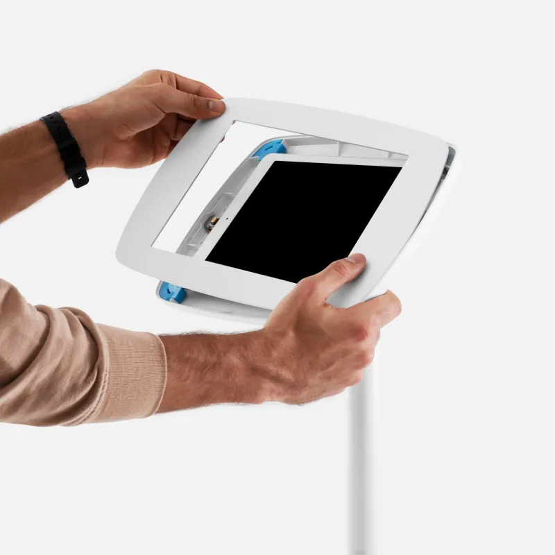 Two hands fitting a tablet into the front of a Bouncepad enclosure